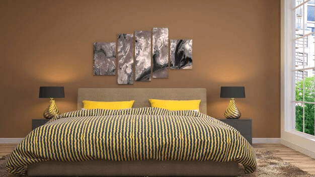 Cozy bedroom with warm yellow accent wall and decorative artwork
