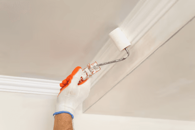 Professional ceiling painting work showing brush application technique